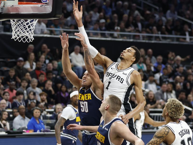 AUSTIN, TX - MARCH 15: Victor Wembanyama #1 of the San Antonio Spurs goes over Aaron Gordon #50 of the Denver Nuggets for a rebound in the first half at Moody Center on March 15, 2024 in Austin, Texas. NOTE TO USER: User expressly acknowledges and agrees that, by downloading and or using this photograph, User is consenting to terms and conditions of the Getty Images License Agreement. (Photo by Ronald Cortes/Getty Images)