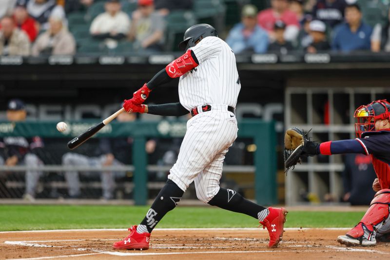 Sep 16, 2023; Chicago, Illinois, USA; Chicago White Sox designated hitter Eloy Jimenez (74) hits a two-run home run against the Minnesota Twins during the first inning at Guaranteed Rate Field. Mandatory Credit: Kamil Krzaczynski-USA TODAY Sports