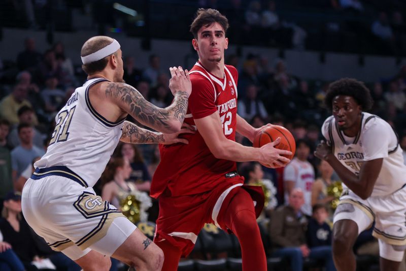 Feb 12, 2025; Atlanta, Georgia, USA; Stanford Cardinal forward Maxime Raynaud (42) is defended by Georgia Tech Yellow Jackets forward Duncan Powell (31) in the first half at McCamish Pavilion. Mandatory Credit: Brett Davis-Imagn Images
