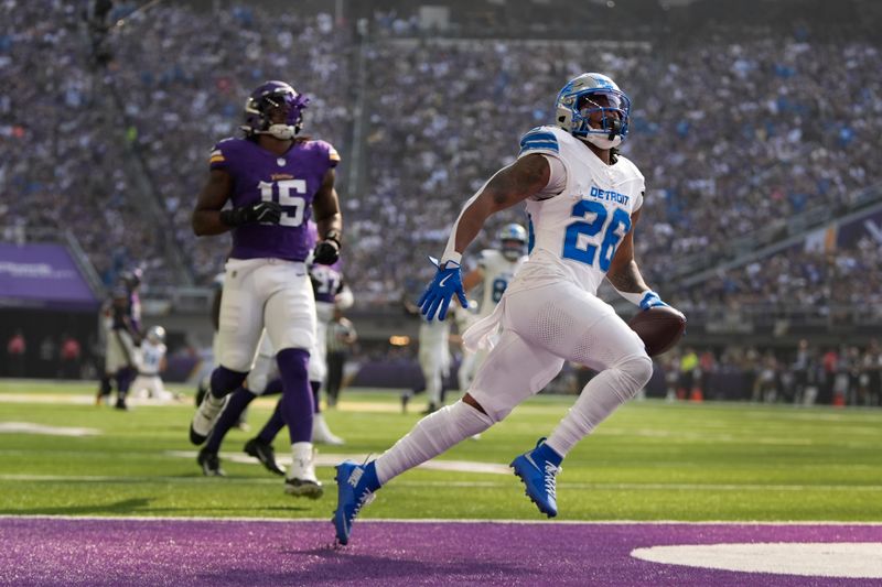 Detroit Lions running back Jahmyr Gibbs (26) runs for a 45-yard touchdown as Minnesota Vikings linebacker Dallas Turner (15) pursues during the first half of an NFL football game Sunday, Oct. 20, 2024, in Minneapolis. (AP Photo/Abbie Parr)