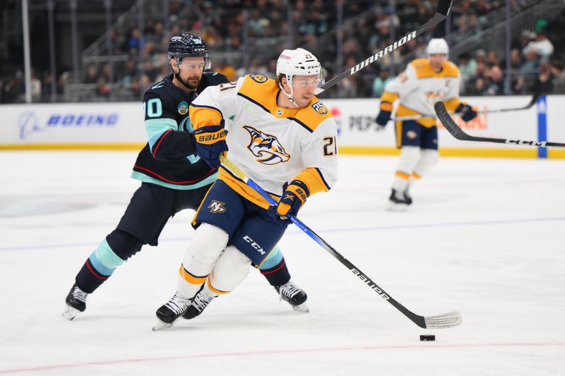 Mar 16, 2024; Seattle, Washington, USA; Nashville Predators left wing Anthony Beauvillier (21) advances the puck while defended by Seattle Kraken left wing Tomas Tatar (90) during the first period at Climate Pledge Arena. Mandatory Credit: Steven Bisig-USA TODAY Sports