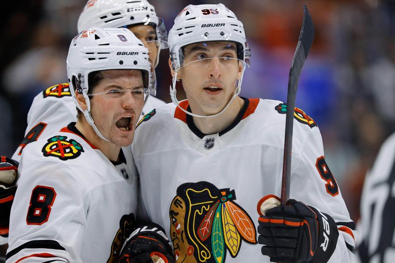 Oct 28, 2024; Denver, Colorado, USA; Chicago Blackhawks center Ryan Donato (8) celebrates his goal with right wing Ilya Mikheyev (95) in the third period against the Colorado Avalanche at Ball Arena. Mandatory Credit: Isaiah J. Downing-Imagn Images