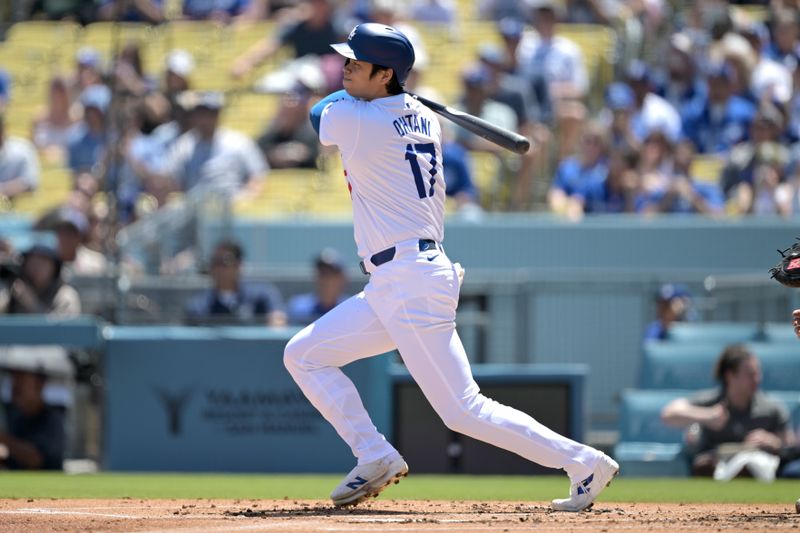 Apr 17, 2024; Los Angeles, California, USA; Los Angeles Dodgers designated hitter player Shohei Ohtani (17) singles in the first inning against the Washington Nationals at Dodger Stadium. Mandatory Credit: Jayne Kamin-Oncea-USA TODAY Sports