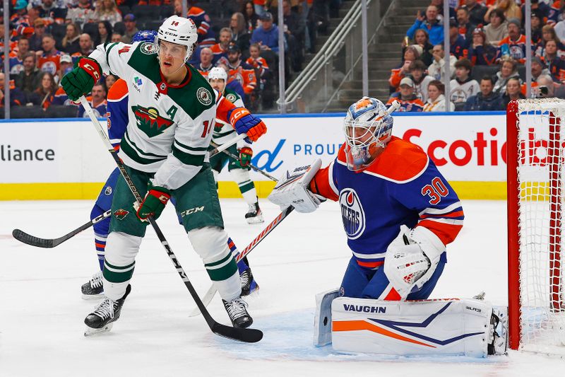 Feb 23, 2024; Edmonton, Alberta, CAN; Minnesota Wild forward Joel Ericksson EK (14) looks for a deletion in front of Edmonton Oilers goaltender Calvin Pickard (30) during the second period at Rogers Place. Mandatory Credit: Perry Nelson-USA TODAY Sports