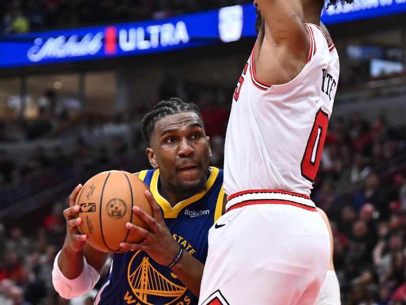 CHICAGO, ILLINOIS - JANUARY 12:  Kevon Looney #5 of the Golden State Warriors is fouled by Coby White #0 of the Chicago Bulls in the second half on January 12, 2024 at United Center in Chicago, Illinois. Golden State defeated Chicago 140-131.   NOTE TO USER: User expressly acknowledges and agrees that, by downloading and or using this photograph, User is consenting to the terms and conditions of the Getty Images License Agreement.  (Photo by Jamie Sabau/Getty Images)