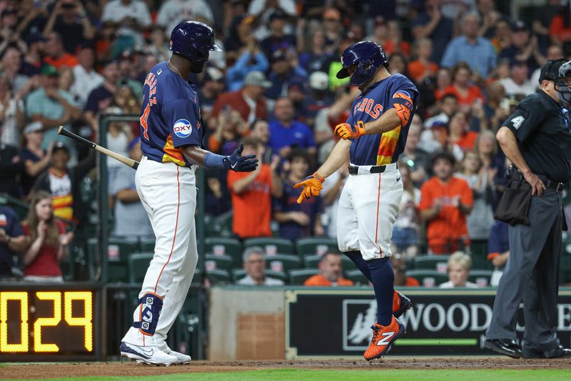 Apr 2, 2024; Houston, Texas, USA; Houston Astros second baseman Jose Altuve (27) celebrates with left fielder Yordan Alvarez (44) after hitting a home run during the fourth inning against the Toronto Blue Jays at Minute Maid Park. Mandatory Credit: Troy Taormina-USA TODAY Sports