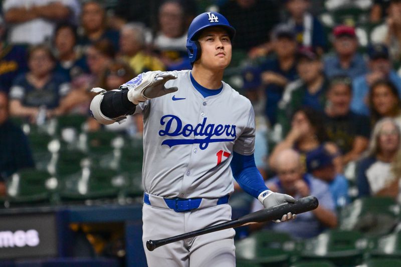 Aug 15, 2024; Milwaukee, Wisconsin, USA; Los Angeles Dodgers designated hitter Shohei Ohtani (17) watches a foul ball in the first inning against the Milwaukee Brewers at American Family Field. Mandatory Credit: Benny Sieu-USA TODAY Sports