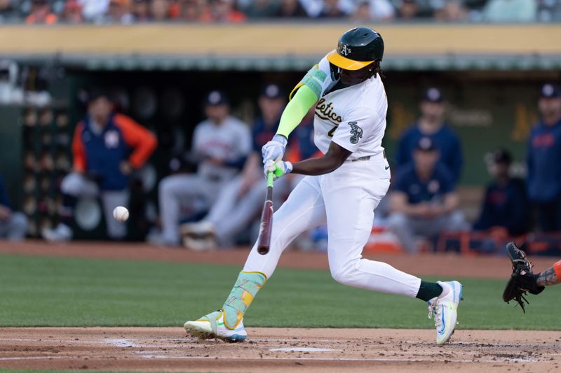 Jul 23, 2024; Oakland, California, USA;  Oakland Athletics outfielder Lawrence Butler (4) hits a triple during the first inning against the Houston Astros at Oakland-Alameda County Coliseum. Mandatory Credit: Stan Szeto-USA TODAY Sports