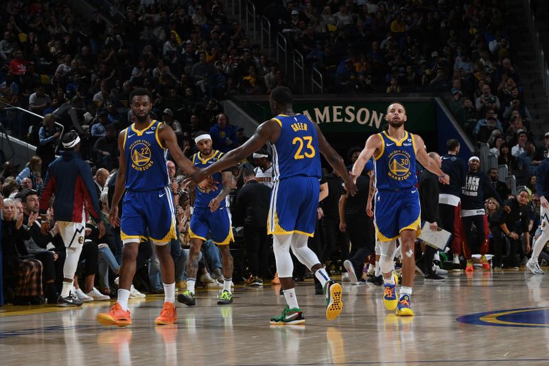 SAN FRANCISCO, CA - FEBRUARY 25:  Andrew Wiggins #22, Draymond Green #23 high fives  Stephen Curry #30 of the Golden State Warriors during the game against the Denver Nuggets on February 25, 2024 at Chase Center in San Francisco, California. NOTE TO USER: User expressly acknowledges and agrees that, by downloading and or using this photograph, user is consenting to the terms and conditions of Getty Images License Agreement. Mandatory Copyright Notice: Copyright 2024 NBAE (Photo by Noah Graham/NBAE via Getty Images)