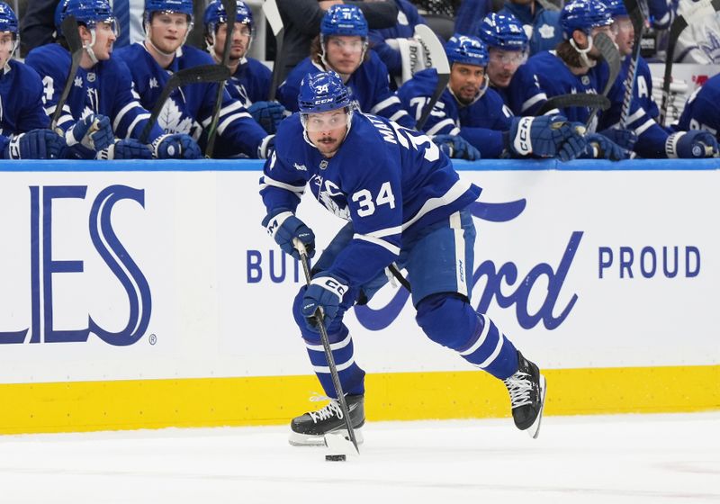 Dec 6, 2024; Toronto, Ontario, CAN; Toronto Maple Leafs center Auston Matthews (34) skates with the puck against the Washington Capitals during  the third period at Scotiabank Arena. Mandatory Credit: Nick Turchiaro-Imagn Images