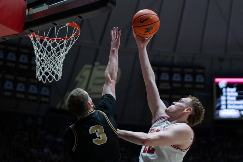 Mar 7, 2026; West Lafayette, Indiana, USA; Wisconsin Badgers forward Austin Rapp (22) attempts to dunk the ball as Purdue Boilermakers guard Braden Smith (3) defends during the first half at Mackey Arena. Mandatory Credit: Jacob Musselman-Imagn Images