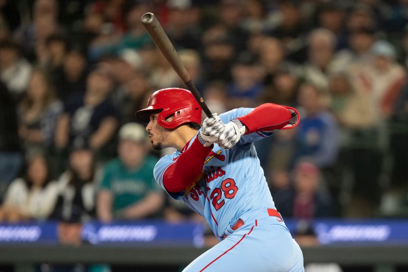 Apr 22, 2023; Seattle, Washington, USA;  St. Louis Cardinals Nolan Arenado (28) hits an RBI-single during the first inning against the Seattle Mariners at T-Mobile Park. Mandatory Credit: Stephen Brashear-USA TODAY Sports