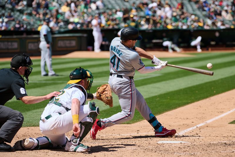 May 5, 2024; Oakland, California, USA; Miami Marlins infielder Jonah Bride (41) hits an RBI single against the Oakland Athletics during the sixth inning at Oakland-Alameda County Coliseum. Mandatory Credit: Robert Edwards-USA TODAY Sports