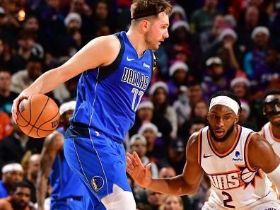 PHOENIX, AZ - DECEMBER 25: Luka Doncic #77 of the Dallas Mavericks handles the ball during the game against the Phoenix Suns on December 25, 2023 at Footprint Center in Phoenix, Arizona. NOTE TO USER: User expressly acknowledges and agrees that, by downloading and or using this photograph, user is consenting to the terms and conditions of the Getty Images License Agreement. Mandatory Copyright Notice: Copyright 2023 NBAE (Photo by Barry Gossage/NBAE via Getty Images)