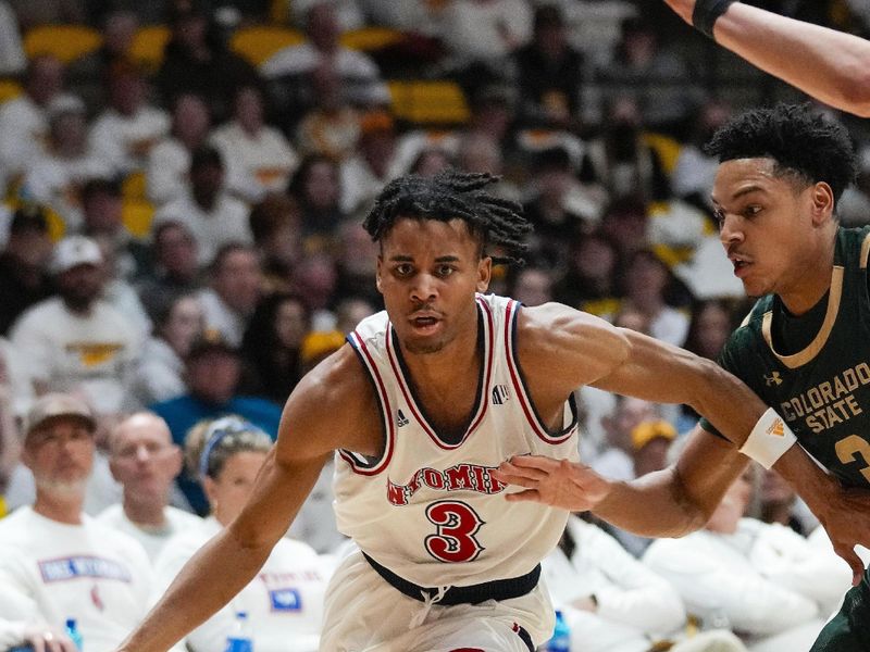 Jan 27, 2024; Laramie, Wyoming, USA; Wyoming Cowboys guard Sam Griffin (3) drives against Colorado State Rams guard Josiah Strong (3) during the first half at Arena-Auditorium. Mandatory Credit: Troy Babbitt-USA TODAY Sports