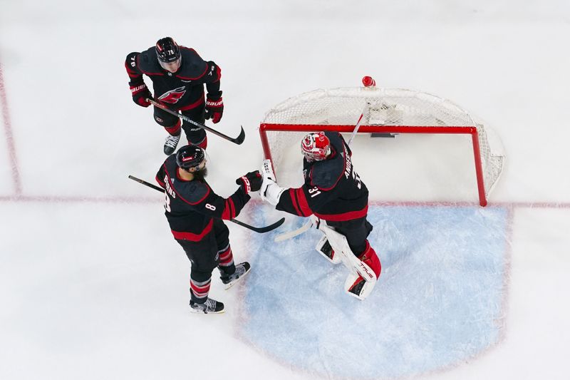 Apr 30, 2024; Raleigh, North Carolina, USA; Carolina Hurricanes goaltender Frederik Andersen (31) defenseman Brent Burns (8) and defenseman Brady Skjei (76) celebrate their win against the New York Islanders in game five of the first round of the 2024 Stanley Cup Playoffs at PNC Arena. Mandatory Credit: James Guillory-USA TODAY Sports