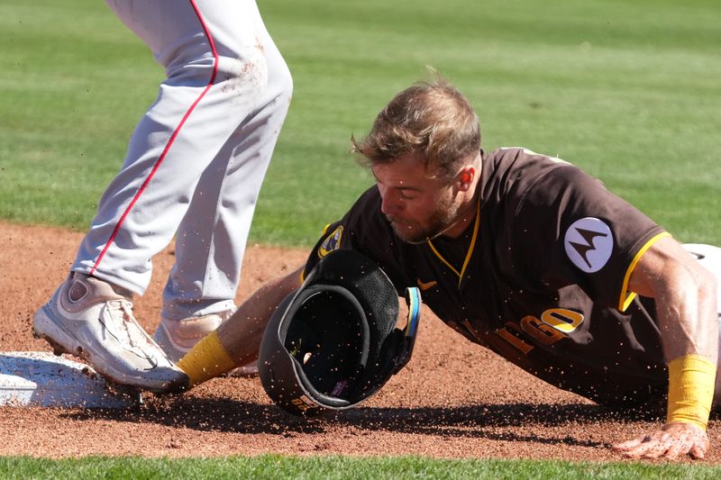 Feb 25, 2025; Peoria, Arizona, USA; San Diego Padres outfielder Brandon Lockridge (28) is picked off at third base against the Los Angeles Angels during the second inning at Peoria Sports Complex. Mandatory Credit: Rick Scuteri-Imagn Images