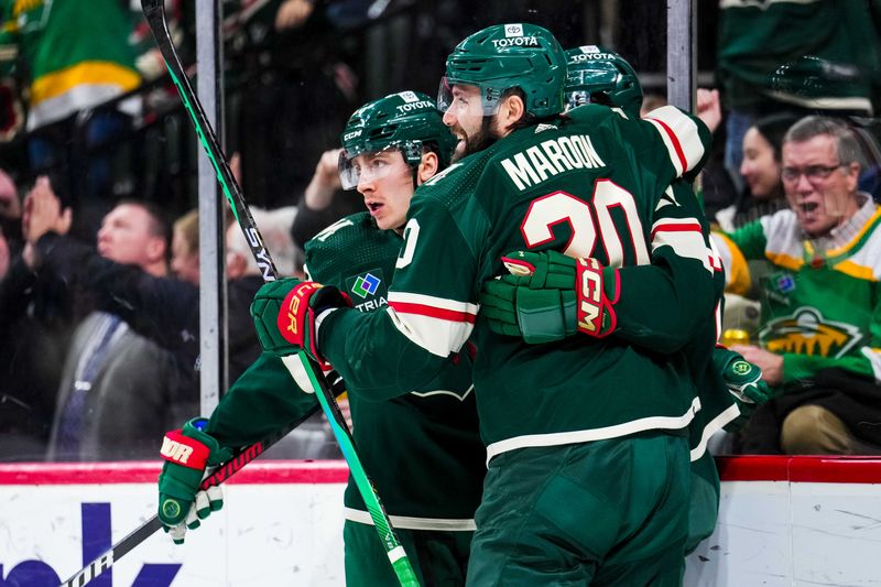 Jan 15, 2024; Saint Paul, Minnesota, USA; Minnesota Wild center Connor Dewar (26) celebrates his goal with left wing Pat Maroon (20) during the second period against the New York Islanders at Xcel Energy Center. Mandatory Credit: Brace Hemmelgarn-USA TODAY Sports