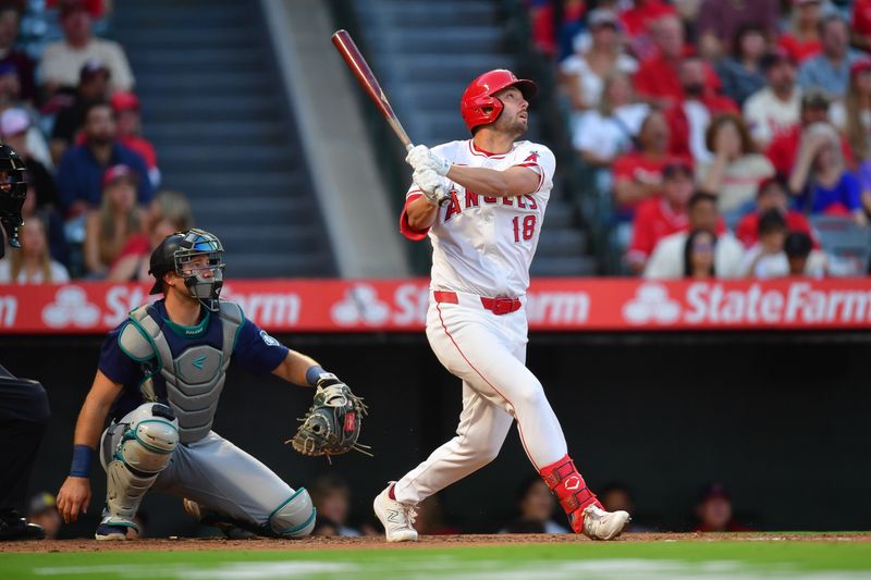 Aug 30, 2024; Anaheim, California, USA;Los Angeles Angels first baseman Nolan Schanuel (18) hits a sacrifice RBI against the Seattle Mariners during the first inning  at Angel Stadium. Mandatory Credit: Gary A. Vasquez-USA TODAY Sports