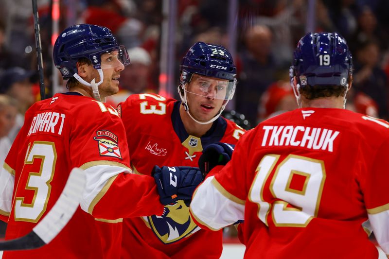 Nov 7, 2024; Sunrise, Florida, USA; Florida Panthers center Carter Verhaeghe (23) celebrates with center Sam Reinhart (13) and left wing Matthew Tkachuk (19) after scoring against the Nashville Predators during the second period at Amerant Bank Arena. Mandatory Credit: Sam Navarro-Imagn Images