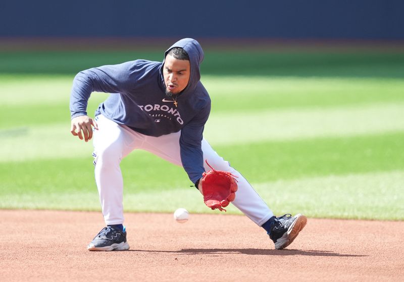 Jun 29, 2023; Toronto, Ontario, CAN; Toronto Blue Jays second baseman Santiago Espinal (5) fields balls during batting practice against the San Francisco Giants at Rogers Centre. Mandatory Credit: Nick Turchiaro-USA TODAY Sports