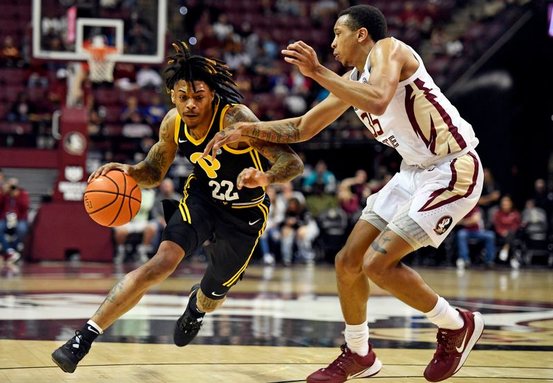Feb 11, 2023; Tallahassee, Florida, USA; Pittsburgh Panthers guard Nike Sibande (22) drives to the net past Florida State Seminoles guard Matthew Cleveland (35) during the second half at Donald L. Tucker Center. Mandatory Credit: Melina Myers-USA TODAY Sports
