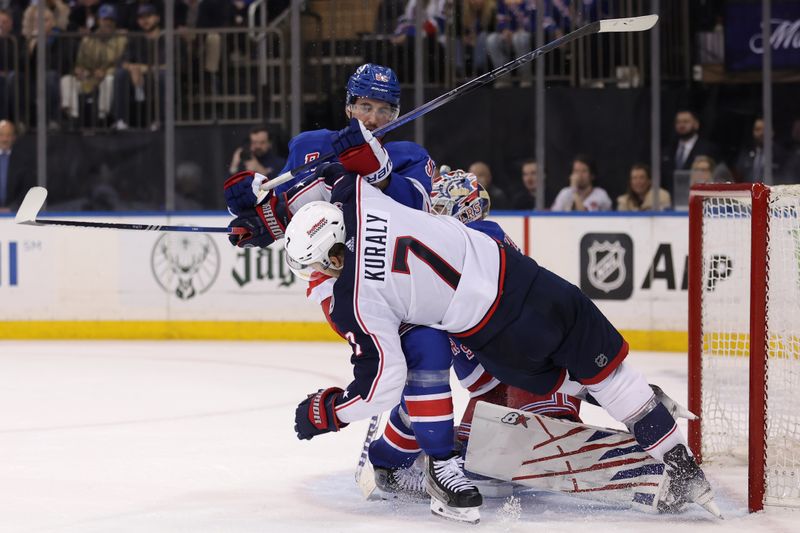 Feb 28, 2024; New York, New York, USA; New York Rangers defenseman Erik Gustafsson (56) knocks Columbus Blue Jackets center Sean Kuraly (7) to the ice in front of Rangers goaltender Igor Shesterkin (31) during the third period at Madison Square Garden. Mandatory Credit: Brad Penner-USA TODAY Sports