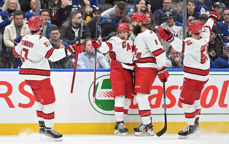 Dec 30, 2023; Toronto, Ontario, CAN; Carolina Hurricanes forward Seth Jarvis (24) celebrates with team mates after scoring a goal against the Toronto Maple Leafs in the second period at Scotiabank Arena. Mandatory Credit: Dan Hamilton-USA TODAY Sports