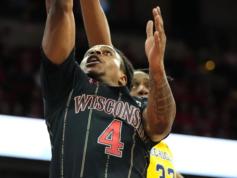 Feb 14, 2023; Madison, Wisconsin, USA;  Wisconsin Badgers guard Kamari McGee (4) shoots the ball under coverage by Michigan Wolverines forward Tarris Reed Jr. (32) during the second half at the Kohl Center. Mandatory Credit: Kayla Wolf-USA TODAY Sports