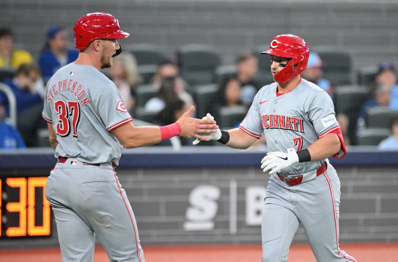 Aug 21, 2024; Toronto, Ontario, CAN;  Cincinnati Reds left fielder Spencer Steer (7) is greeted at home plate by catcher Tyler Stephenson (37) after hitting a two run home run against the Toronto Blue Jays in the fourth inning at Rogers Centre. Mandatory Credit: Dan Hamilton-USA TODAY Sports