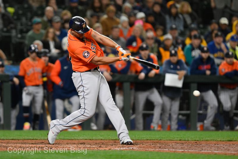 Sep 27, 2023; Seattle, Washington, USA; Houston Astros first baseman Jose Abreu (79) hits an RBI single against the Seattle Mariners during the seventh inning at T-Mobile Park. Mandatory Credit: Steven Bisig-USA TODAY Sports