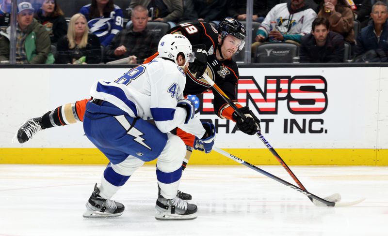 Mar 24, 2024; Anaheim, California, USA; Anaheim Ducks left wing Max Jones (49) shoots against Tampa Bay Lightning defenseman Nick Perbix (48) during the second period at Honda Center. Mandatory Credit: Jason Parkhurst-USA TODAY Sports