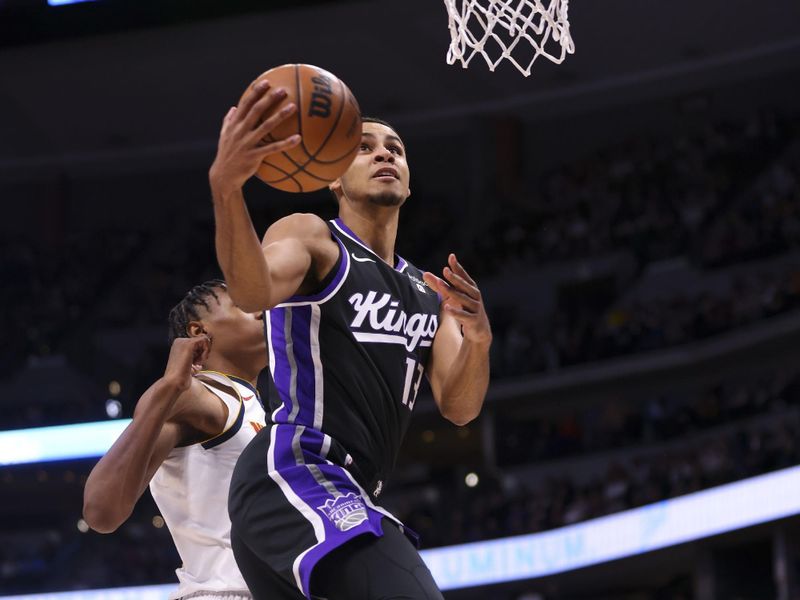 DENVER, COLORADO - FEBRUARY 28: Keegan Murray #13 of the Sacramento Kings goes for a layup while Peyton Watson #8 of the Denver Nuggets defends during the game at Ball Arena on February 28, 2024 in Denver, Colorado. NOTE TO USER: User expressly acknowledges and agrees that, by downloading and or using this photograph, User is consenting to the terms and conditions of the Getty Images License Agreement. (Photo by Alysa Rubin/Clarkson Creative/Getty Images)