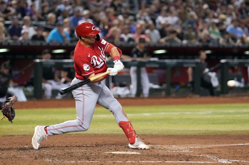 Aug 26, 2023; Phoenix, Arizona, USA; Cincinnati Reds first baseman Spencer Steer (7) hits an RBI double against the Arizona Diamondbacks during the tenth inning at Chase Field. Mandatory Credit: Joe Camporeale-USA TODAY Sports