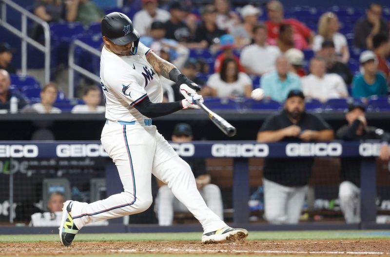 Jun 18, 2024; Miami, Florida, USA;  Miami Marlins catcher Christian Bethancourt (25) hits a solo home run against the St. Louis Cardinals in the sixth inning at loanDepot Park. Mandatory Credit: Rhona Wise-USA TODAY Sports