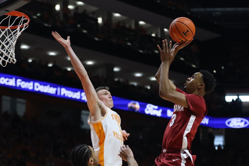 Jan 20, 2024; Knoxville, Tennessee, USA; Alabama Crimson Tide guard Rylan Griffen (3) shoots the ball against Tennessee Volunteers guard Dalton Knecht (3) during the first half at Thompson-Boling Arena at Food City Center. Mandatory Credit: Randy Sartin-USA TODAY Sports