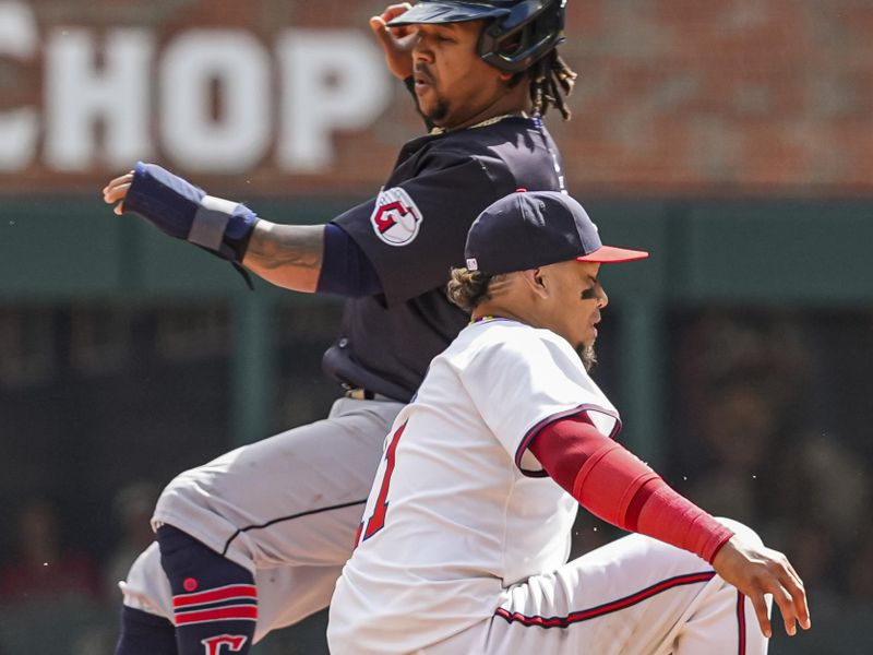 Apr 26, 2024; Cumberland, Georgia, USA; Cleveland Guardians third baseman Jose Ramirez (11) is tagged out by Atlanta Braves shortstop Orlando Arcia (11) while trying to steal second base during the tenth inning at Truist Park. Mandatory Credit: Dale Zanine-USA TODAY Sports