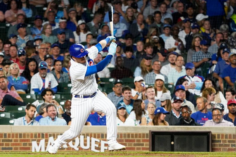 Jul 18, 2023; Chicago, Illinois, USA; Chicago Cubs left fielder Ian Happ (8) hits a single against the Washington Nationals during the sixth inning at Wrigley Field. Mandatory Credit: David Banks-USA TODAY Sports