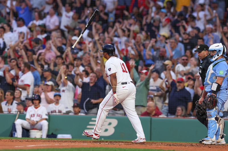 Jun 24, 2024; Boston, Massachusetts, USA; Boston Red Sox third baseman Rafael Devers (11) hits a two run home run during the fourth inning against the Toronto Blue Jays at Fenway Park. Mandatory Credit: Paul Rutherford-USA TODAY Sports