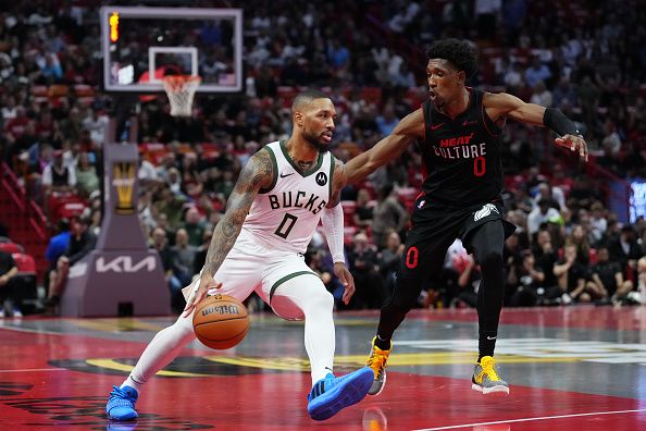 MIAMI, FLORIDA - NOVEMBER 28: Damian Lillard #0 of the Milwaukee Bucks dribbles the ball past Josh Richardson #0 of the Miami Heat in the first quarter during the NBA In-season Tournament game at Kaseya Center on November 28, 2023 in Miami, Florida. NOTE TO USER: User Expressly acknowledges and agrees that, by downloading and or using this photograh, User is consenting to the terms and conditions of the Getty Images License Agreement. (Photo by Rich Storry/Getty Images)