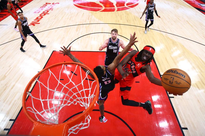 TORONTO, CANADA - MARCH 20: Mouhamadou Gueye #16 of the Toronto Raptors drives to the basket during the game against the Sacramento Kings on March 20, 2024 at the Scotiabank Arena in Toronto, Ontario, Canada.  NOTE TO USER: User expressly acknowledges and agrees that, by downloading and or using this Photograph, user is consenting to the terms and conditions of the Getty Images License Agreement.  Mandatory Copyright Notice: Copyright 2024 NBAE (Photo by Vaughn Ridley/NBAE via Getty Images)