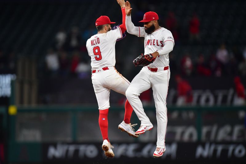 May 6, 2025; Anaheim, California, USA; Los Angeles Angels shortstop Zach Neto (9) and outfielder Jo Adell (7) celebrate the victory against the Toronto Blue Jays at Angel Stadium. Mandatory Credit: Gary A. Vasquez-Imagn Images