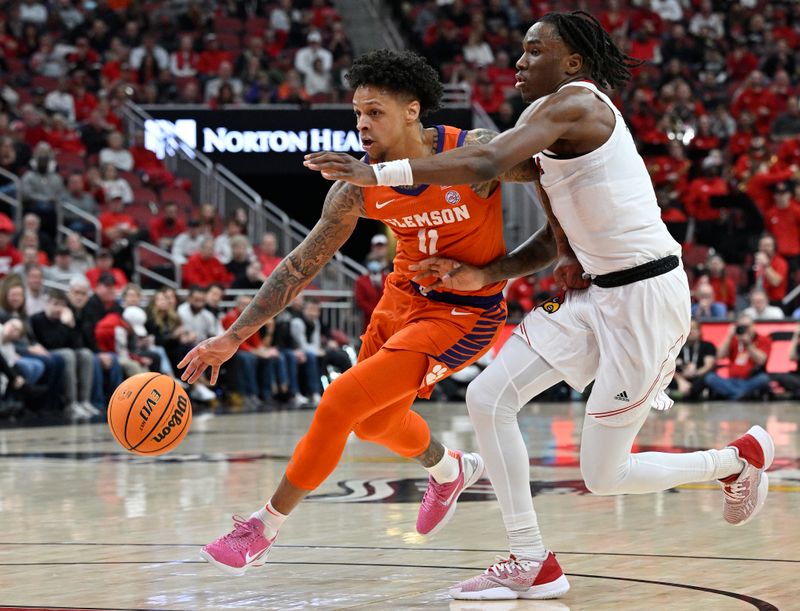 Feb 18, 2023; Louisville, Kentucky, USA;  Clemson Tigers guard Brevin Galloway (11) dribbles against Louisville Cardinals guard Mike James (1) during the first half at KFC Yum! Center. Mandatory Credit: Jamie Rhodes-USA TODAY Sports