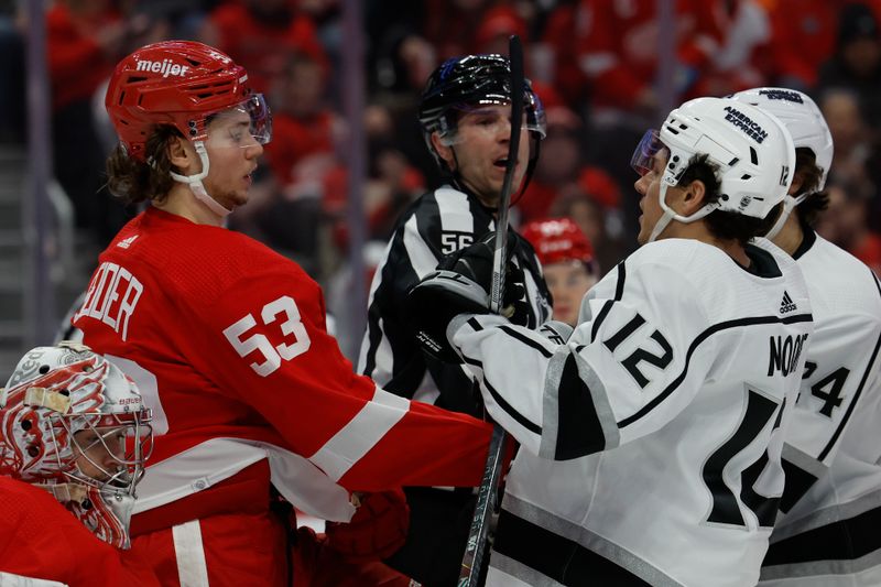 Jan 13, 2024; Detroit, Michigan, USA;  Detroit Red Wings defenseman Moritz Seider (53) and Los Angeles Kings left wing Trevor Moore (12) shove each other in the third period at Little Caesars Arena. Mandatory Credit: Rick Osentoski-USA TODAY Sports