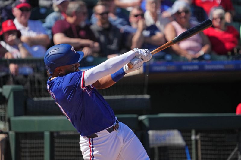 Mar 4, 2024; Surprise, Arizona, USA; Texas Rangers shortstop Ezequiel Duran (20) bats against the Los Angeles Angels during the second inning at Surprise Stadium. Mandatory Credit: Joe Camporeale-USA TODAY Sports