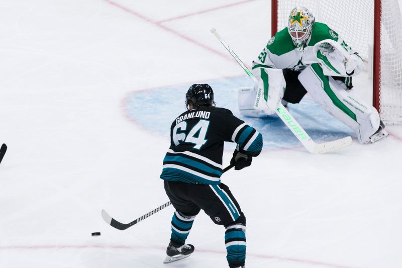 Mar 5, 2024; San Jose, California, USA; Dallas Stars goaltender Jake Oettinger (29) defends against a shot by San Jose Sharks center Mikael Granlund (64) during the third period at SAP Center at San Jose. Mandatory Credit: John Hefti-USA TODAY Sports