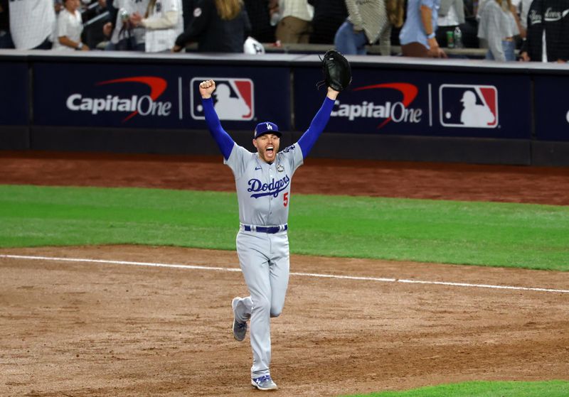 Oct 30, 2024; Bronx, New York, USA; Los Angeles Dodgers first baseman Freddie Freeman celebrates after the final out against the New York Yankees during game five of the 2024 MLB World Series at Yankee Stadium. Mandatory Credit: James Lang-Imagn Images