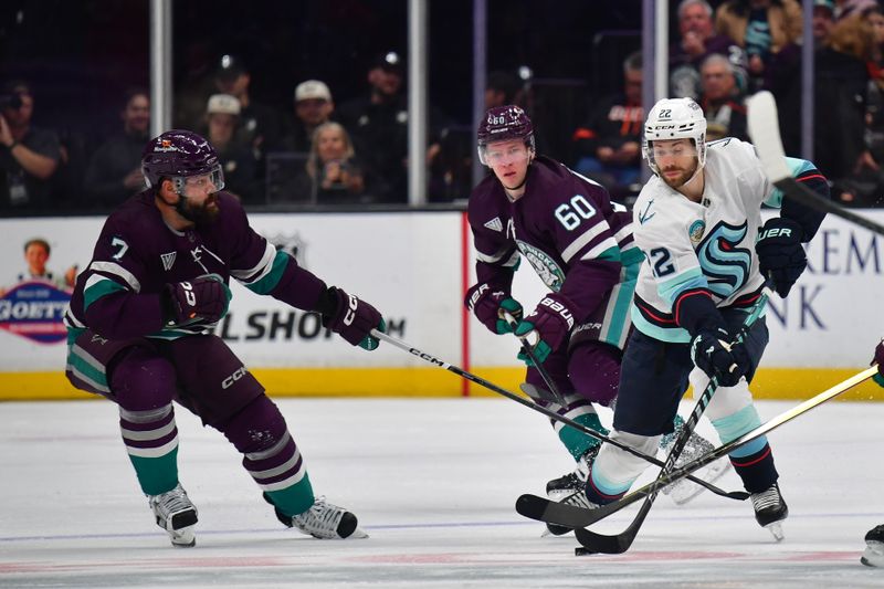 Apr 5, 2024; Anaheim, California, USA; Seattle Kraken right wing Oliver Bjorkstrand (22) moves the puck against Anaheim Ducks defenseman Radko Gudas (7) during the second period at Honda Center. Mandatory Credit: Gary A. Vasquez-USA TODAY Sports