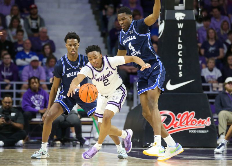 Feb 24, 2024; Manhattan, Kansas, USA; Kansas State Wildcats guard Tylor Perry (2) loses the ball while guarded by Brigham Young Cougars forward Atiki Ally Atiki (4) during the second half at Bramlage Coliseum. Mandatory Credit: Scott Sewell-USA TODAY Sports