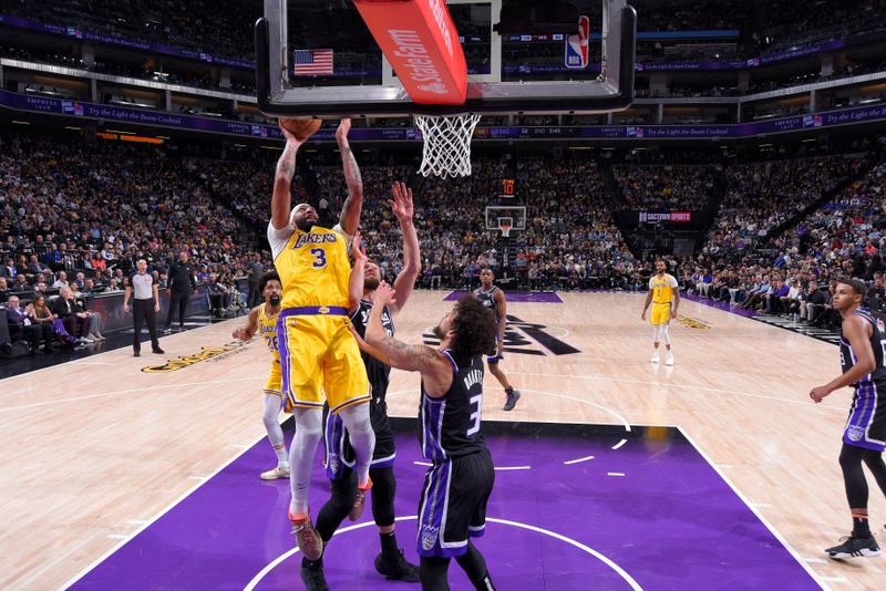 SACRAMENTO, CA - MARCH 13:  Anthony Davis #3 of the Los Angeles Lakers drives to the basket during the game against the Sacramento Kings on March 13, 2024 at Golden 1 Center in Sacramento, California. NOTE TO USER: User expressly acknowledges and agrees that, by downloading and or using this Photograph, user is consenting to the terms and conditions of the Getty Images License Agreement. Mandatory Copyright Notice: Copyright 2024 NBAE (Photo by Rocky Widner/NBAE via Getty Images)